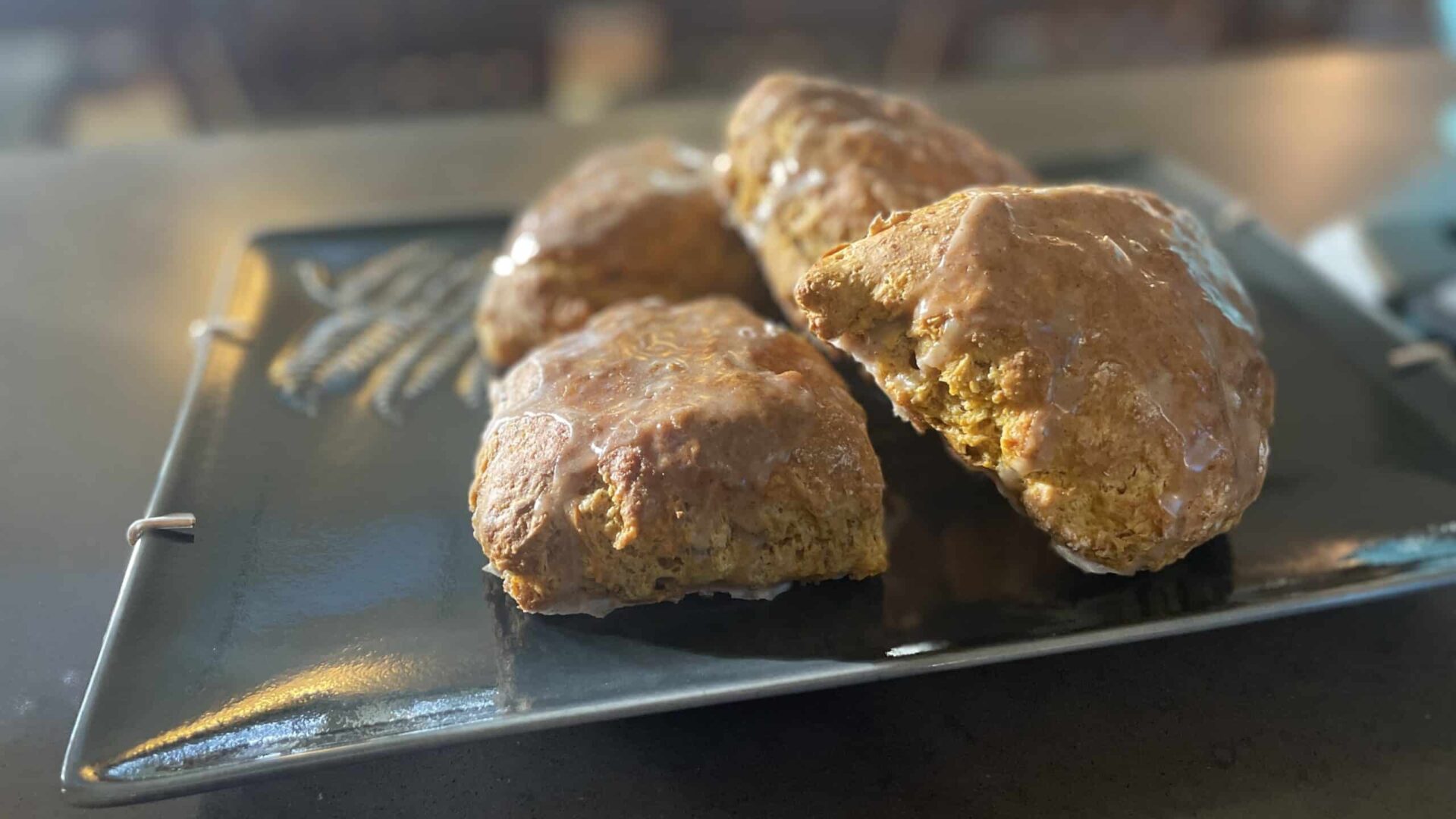 Golden Pumpkin Spice Scones on a dark green platter