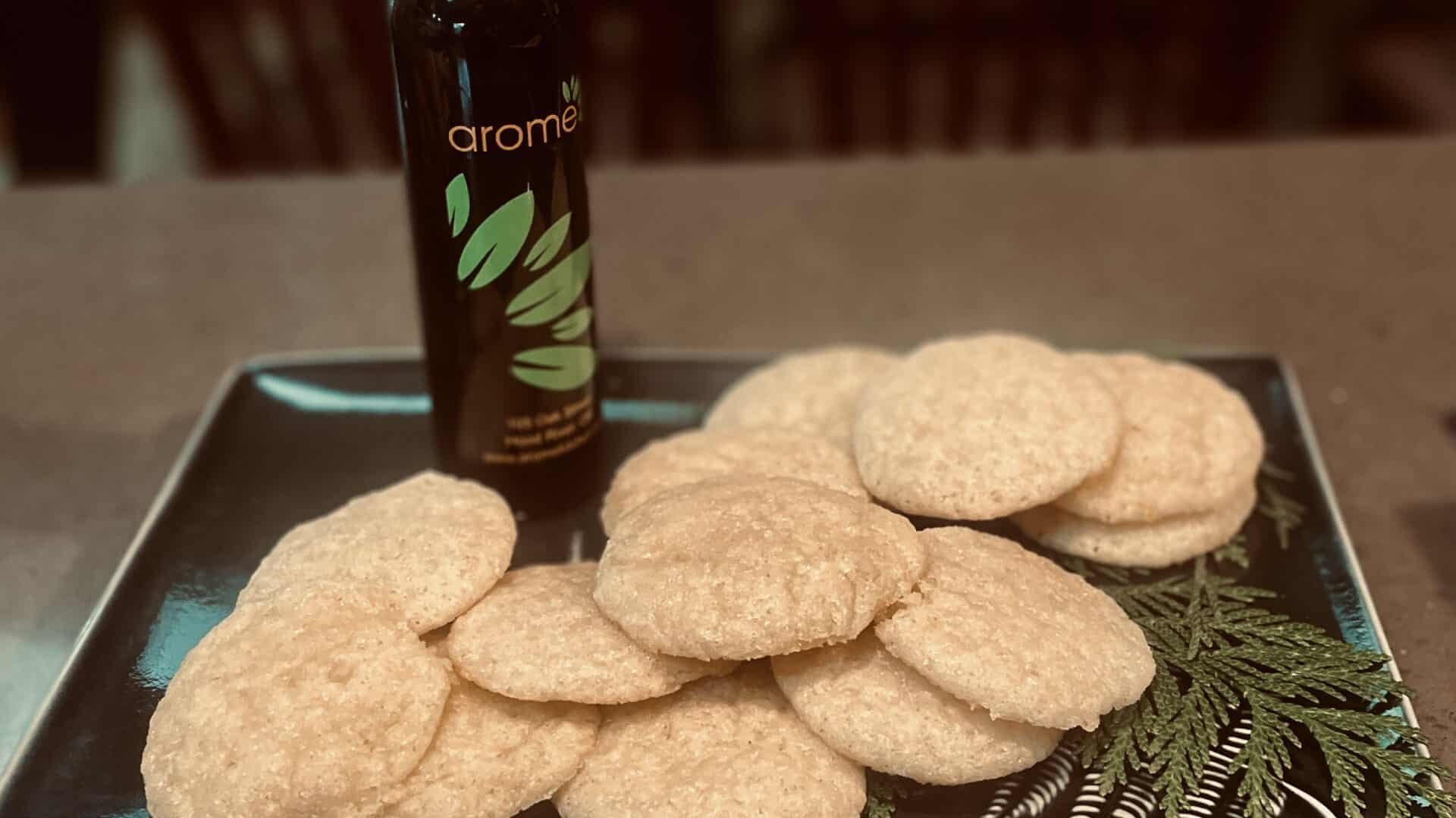 Lemon Olive Oil Sugar Cookies on a green plate and a bottle of oil