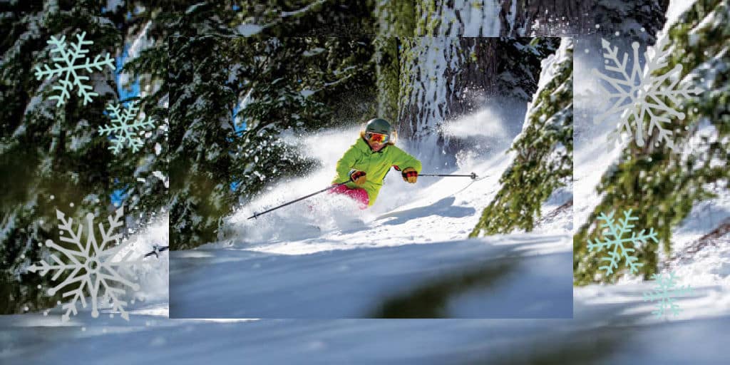 A skier in deep powder in the trees